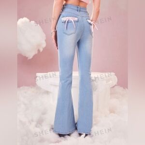 Light blue flare jeans with pink bows